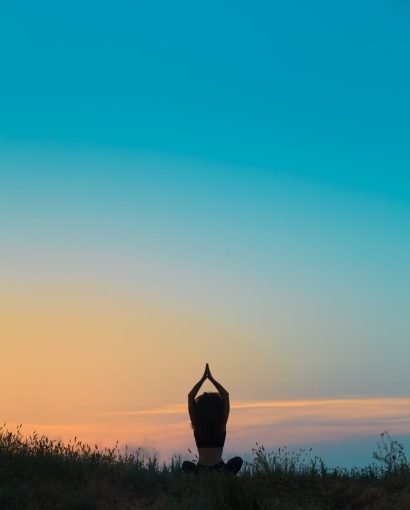 The silhouette of young woman is practicing yoga Silhouette of young woman is practicing yoga at sunset