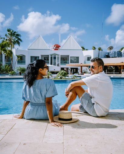 Luxury resort with swimming pool near Palm Beach Aruba Luxury resort with swimming pool near Palm Beach Aruba Caribbean, couple man and woman mid age on a luxury vacation in the Caribbean
