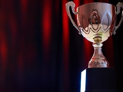 trophy against stage red light on curtain as background trophy against stage red light on curtain as background